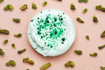 Pattern of plants and a jar of cream on a pink background