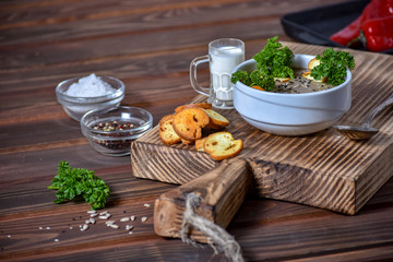 Mushroom cream soup on wooden background, selective focus
