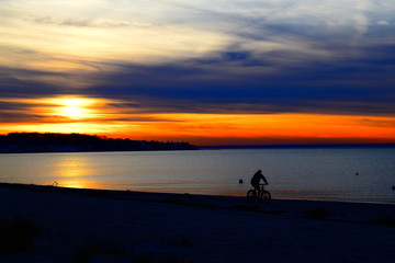 Naklejka na ściany i meble Biking at Sunset