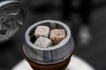 Close-up of a top of hookah with coconut coal.
