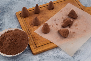 Sweet dessert - chocolate truffles sprinkled with cocoa powder.