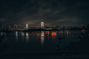 The Rainbow Bridge of Tokyo lit up at night.  Capital city of Japan
