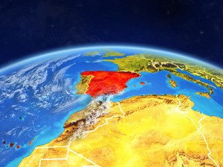 Fototapeta premium Spain on planet Earth with country borders and highly detailed planet surface and clouds.