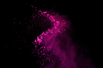 Pink powder explosion on black background. Colored cloud. Colorful dust explode. Paint Holi.