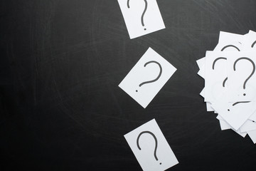 Question mark heap on table concept for confusion, question or solution