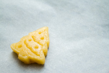 Christmas cookies for children, making gingerbread in form of fir tree close-up. Recipe and raw dough of New year treat. Homemade bakery, xmas sweet, winter holidays concept. copyspace.