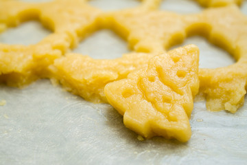 Raw dough for christmas cookies for children, making gingerbread in form of fir tree close-up. Recipe of New year treat. Homemade bakery, xmas sweet, winter holidays concept