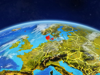 Fototapeta premium Denmark on planet Earth with country borders and highly detailed planet surface and clouds.