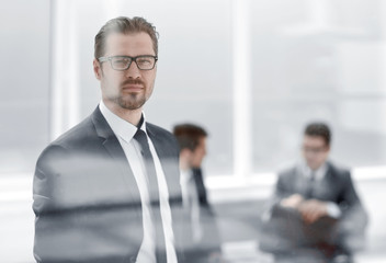 Fototapeta premium confident businessman looking through the office window