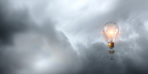 Glass bulb in blue sky. Mixed media