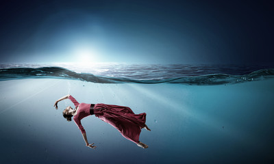 Woman dancer in clear blue water
