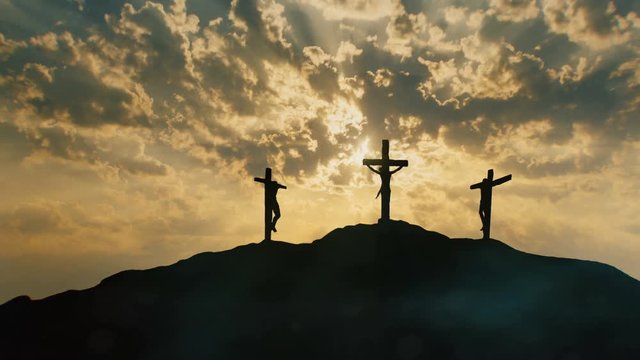 Calvary hill outside ancient Jerusalem where Jesus Christ was crucified. Three silhouettes of Crosses with mystical clouds and rays of light.