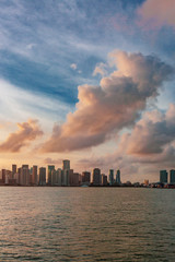 Skyline of downtown Miami from the sea under sky and clouds at sunset, in Florida, USA