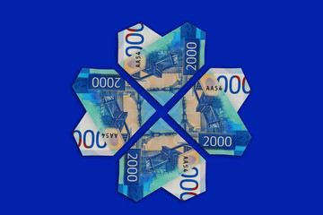 Four banknote of two thousand rubles folded in the shape of a heart. From Russia with love. The blue isolated background