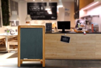 Blank menu board stand infront of restaurant with blurred background