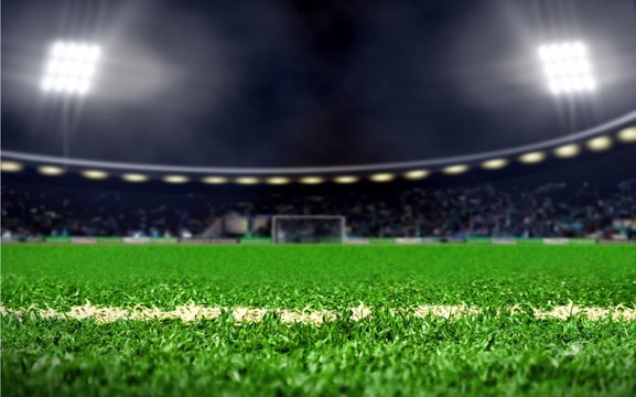 Empty  Soccer Field Stadium With Green Grass And Bright Spotlights At Night