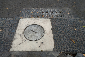 Drainage cover made of concrete in via publica, latin america. Guatemala.