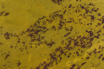 Rust metal surface with yellow paint flaking and cracking  for interior exterior decoration.