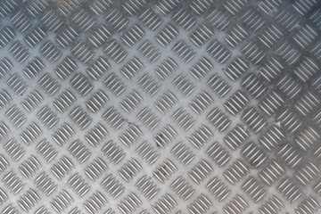 Texture of metal floor plate with diamond pattern.