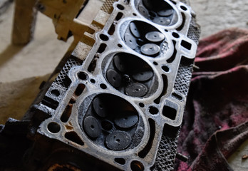 Valve in a deposit on the removed cover of the engine valve box. Engine repair. Imprint of the...