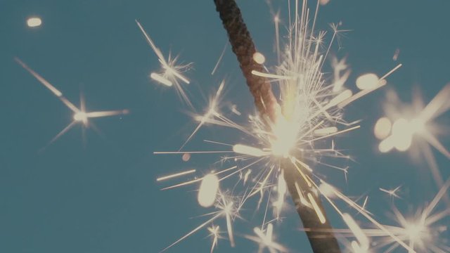 Ignite a fire spark on a blue background.
You can easily key out the background, or use soft light/overlay blending mode for adding to your composition. 
Slow motion shot.