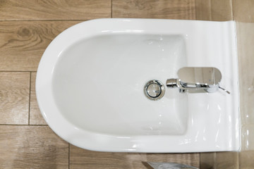 White ceramic bidet in modern bathroom. wc.