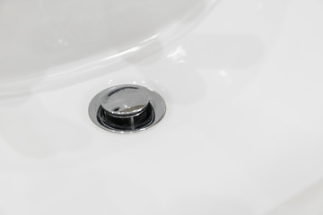 Details of ceramic white sink in the modern bathroom.