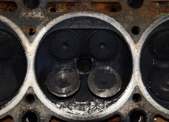 Valve in a deposit on the removed cover of the engine valve box. Engine repair. Imprint of the...