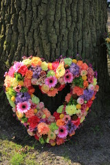 Pastel Sympathy flowers near a tree