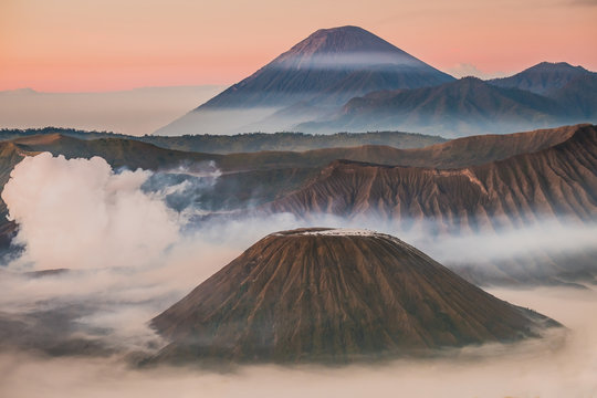 Mount Bromo volcano (Gunung Bromo), and Batok during sunrise from viewpoint on Mount Penanjakan, in East Java, Indonesia. Early morning.