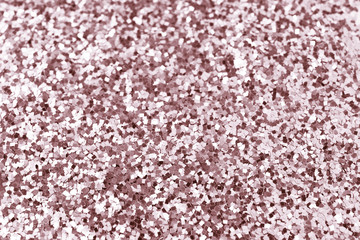 Rose gold glitter confetti background texture.