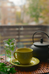 Yellow tea cup infront of a window