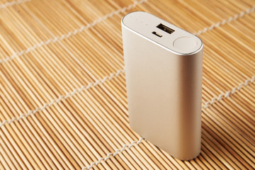 gray powerbank on wooden background