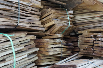 Pile chopped logs, tropical wood for firewood, industry, agriculture and house decoration at wood factory. 