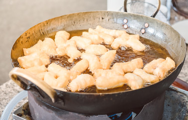 deep fried dough stick in pan of oil. Pansy food of Thailand.