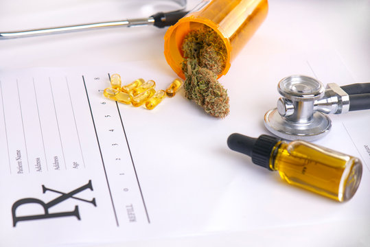 Assorted Cannabis Products, Pills And Cbd Oil Over Medical Prescription Sheet