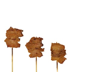 The grilled pork with wood stick which is one of street food in Thailand isolated on white...
