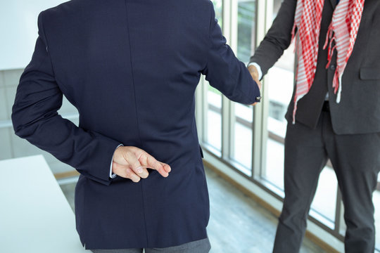 Arabian Business man shaking hand with lie sign
