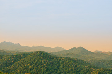 The morning scene with sunlight shining on the landscape of mountain with forest in rural area at the north of Thailand.