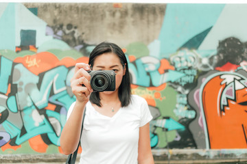Woman enjoy taking photo of an unknown abandoned building.