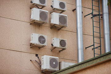 Many air conditioning on the wall of the building