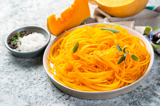 Butternut squash vegetarian noodles on rustic background, copy space