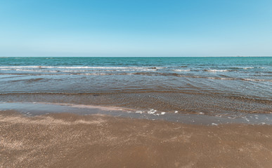 Fototapeta na wymiar Empty beach with turquoise water and hot sand