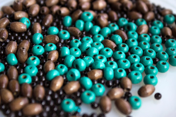 Brown and turquoise wooden beads background. Handmade