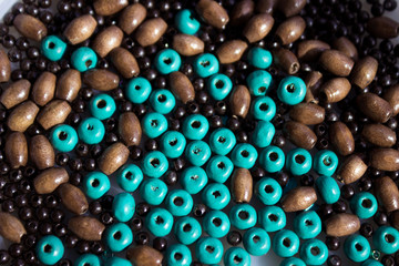 Brown and turquoise wooden beads background. Handmade