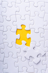 White jigsaw puzzle with selective focus and crop fragment