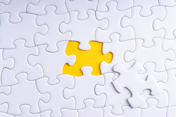 Fototapeta premium White jigsaw puzzle with selective focus and crop fragment