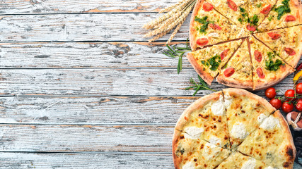 Pizza. Italian cuisine. On a white wooden background. Free space for text. Top view.