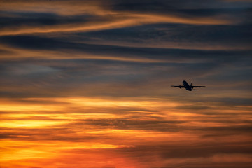 Silhouette plane take off in beautiful sky