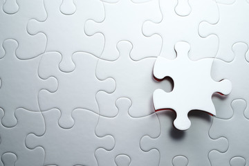 Last piece of jigsaw puzzle. Solving and completing the task.The correct solution. Assembling white...